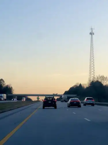 On the road, bathed in the soft glow of twilight.